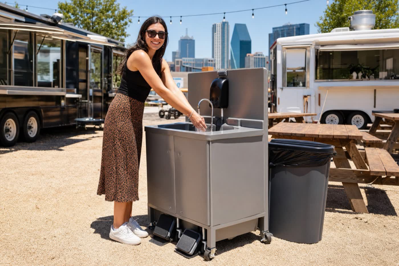 A woman using a foot-pump hand-wash station at a Dallas food truck park